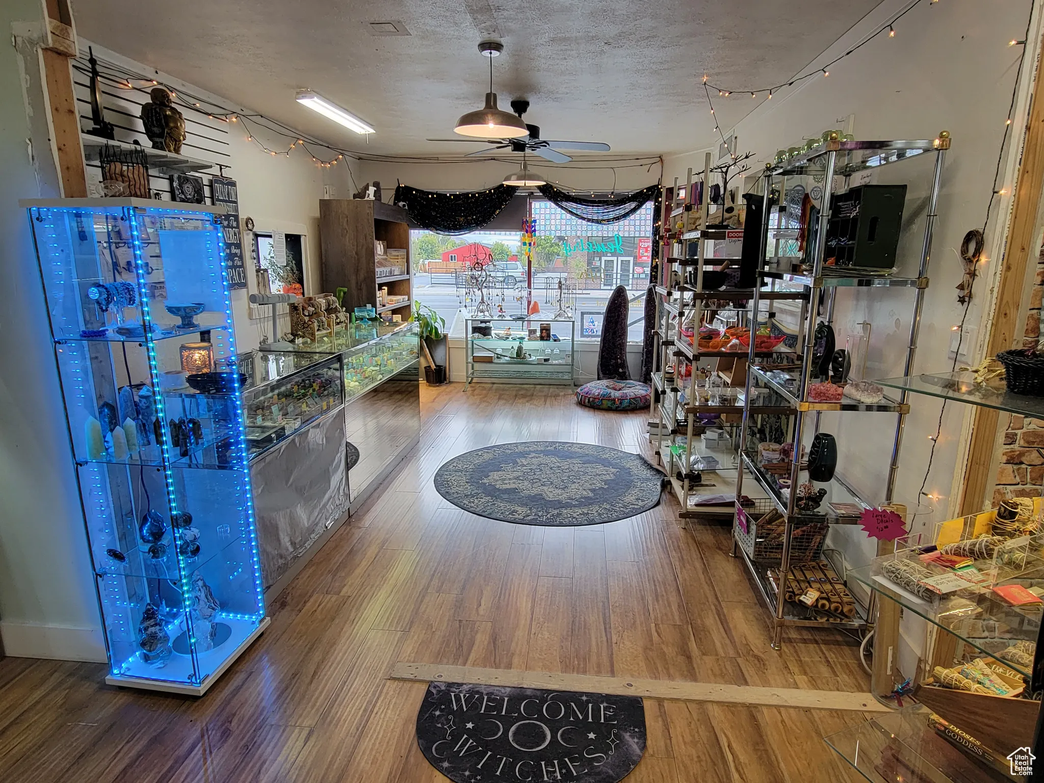 Showroom with ceiling fan and a textured ceiling