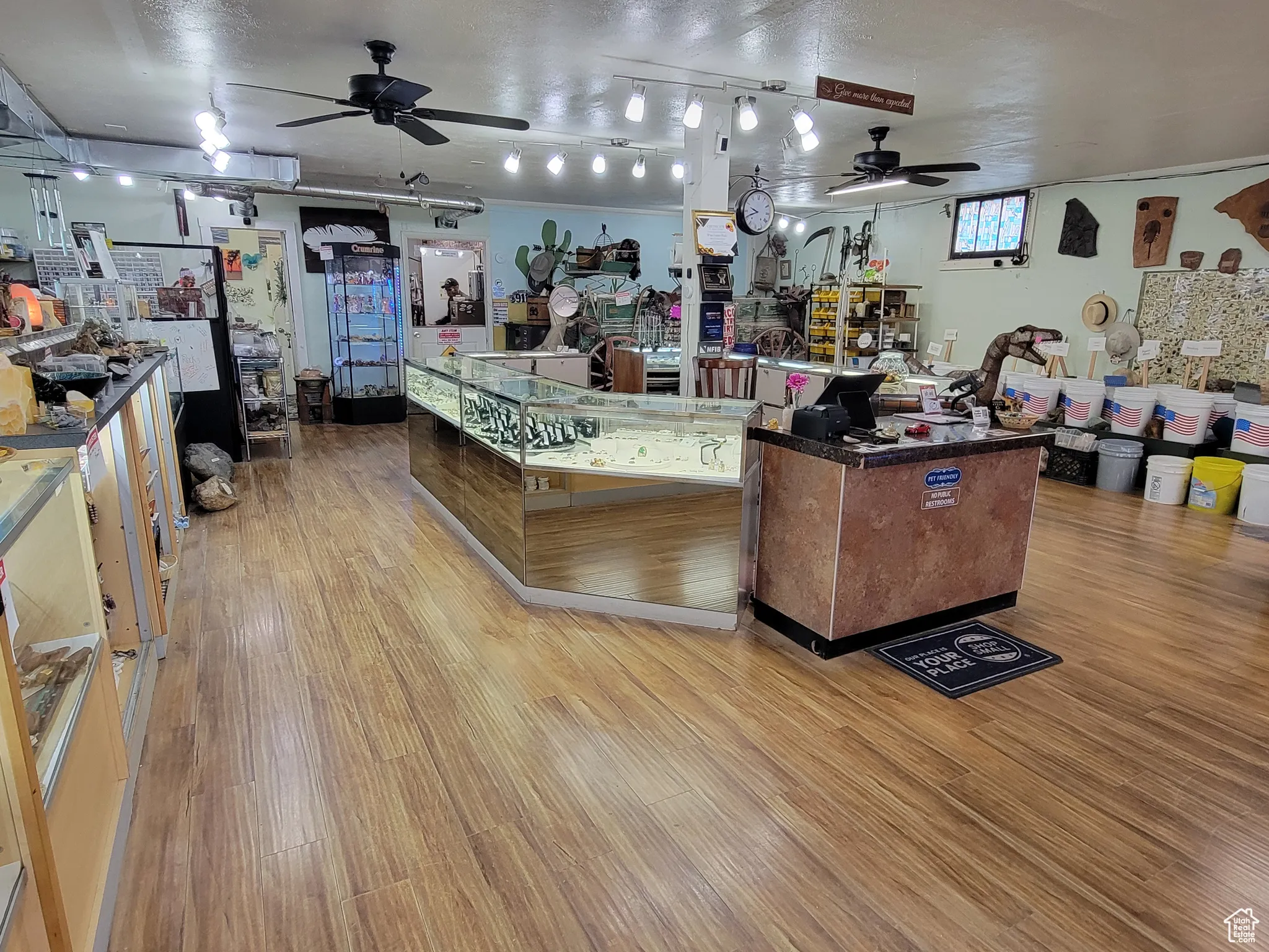 Showroom featuring a ceiling fan and dark countertops