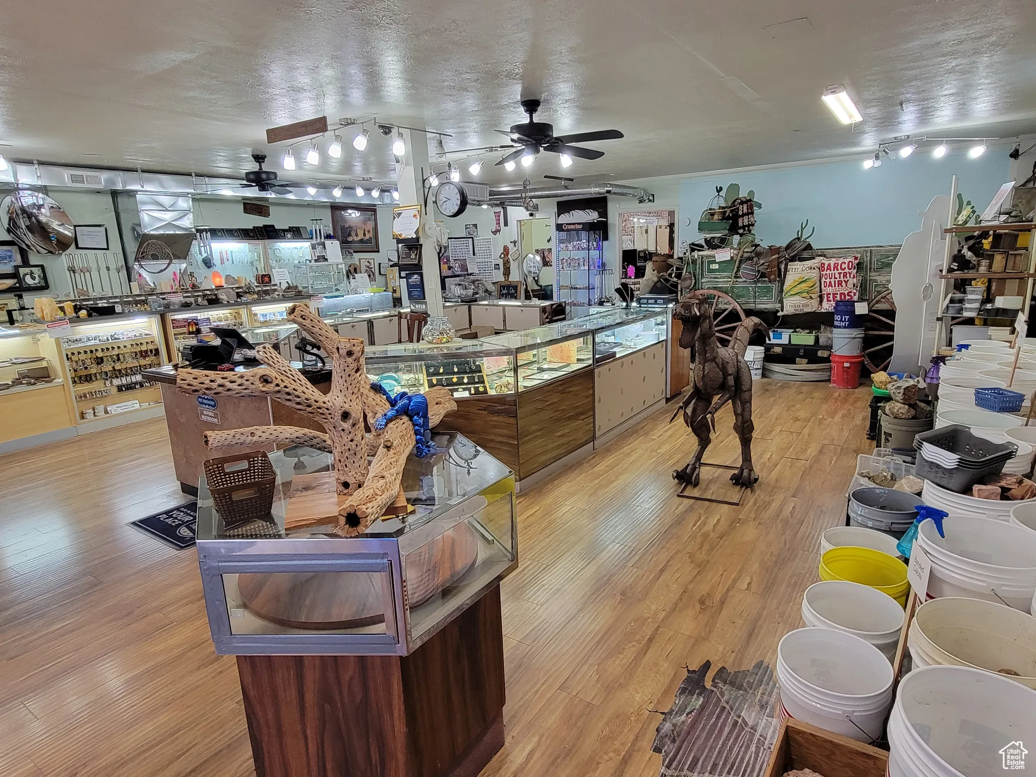 Showroom with a ceiling fan and a textured ceiling