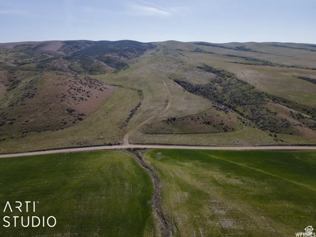 Aerial overview of property's location with a mountain backdrop and rural landscape