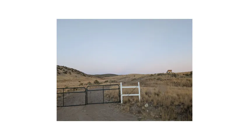 Yard at dusk featuring a gate
