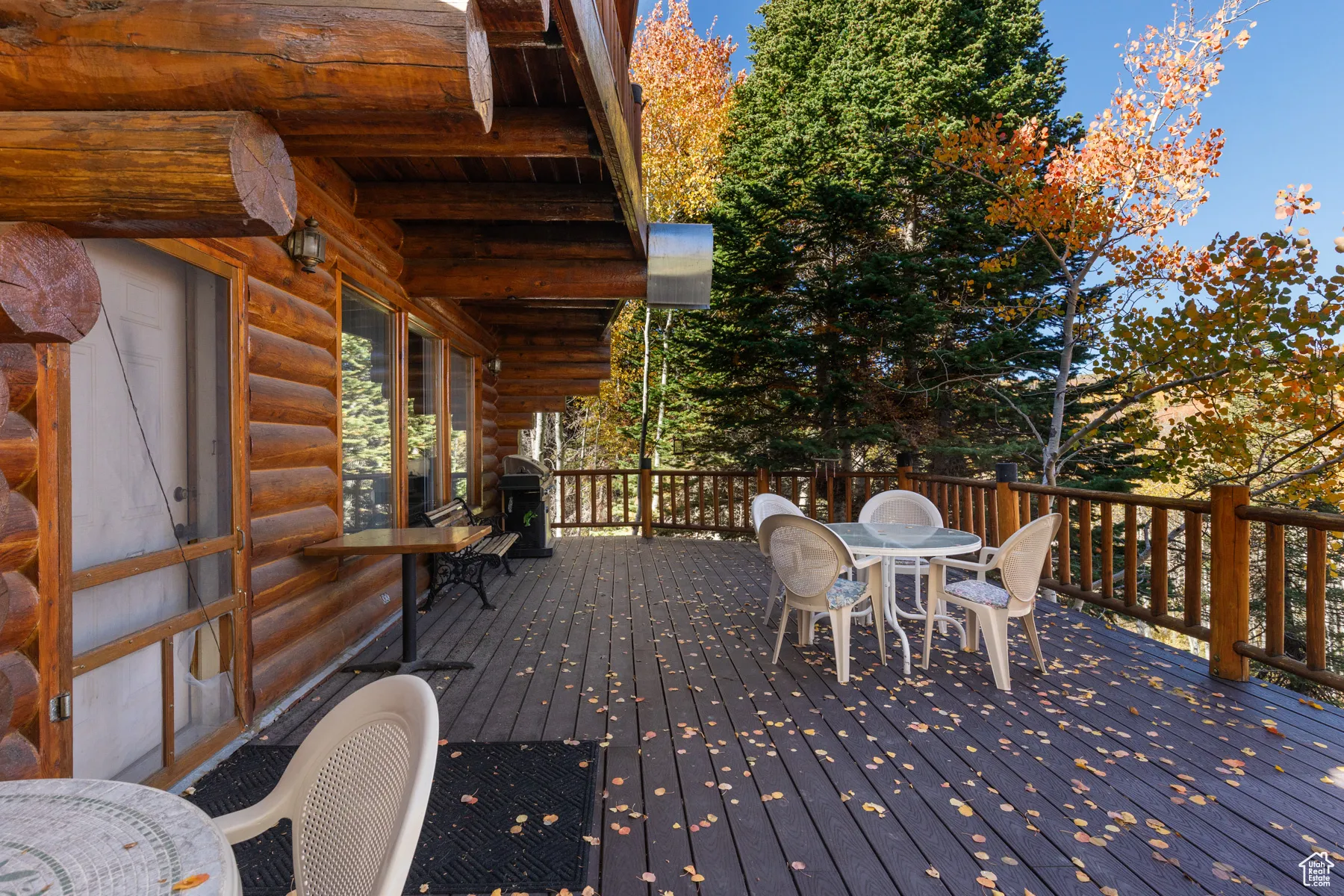 Wooden terrace featuring outdoor dining area and area for grilling