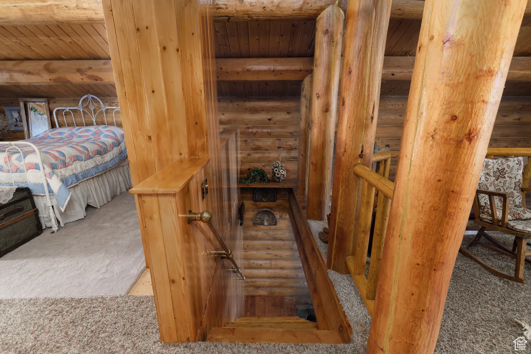 Stairs featuring carpet floors and a wood ceiling with exposed beams