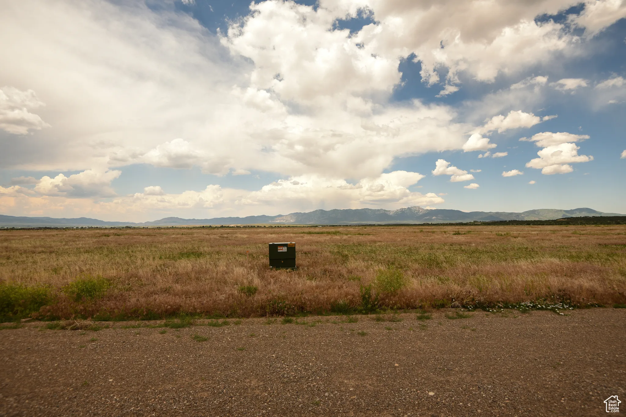 View of mountain backdrop with rural landscape