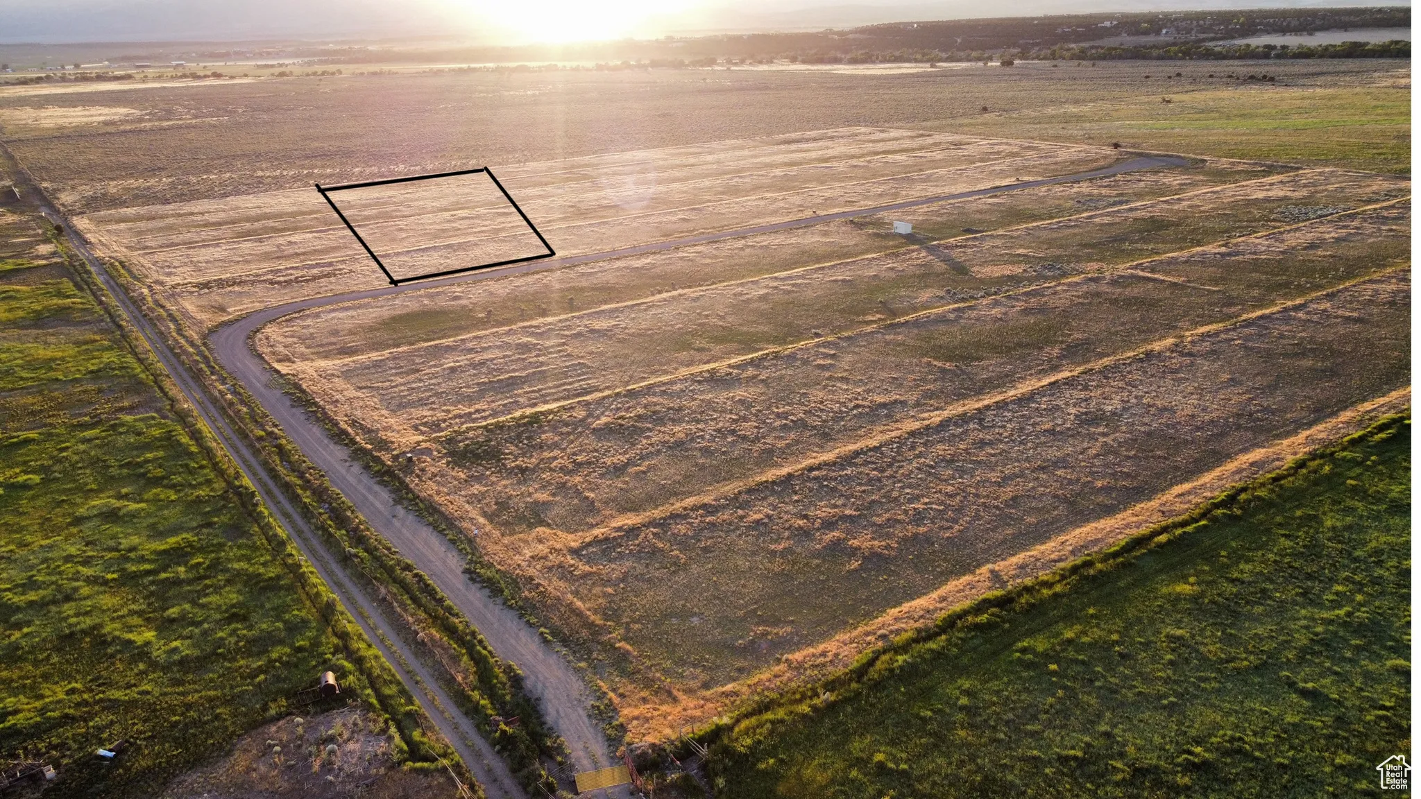 Overview of rural landscape featuring large plots for crops