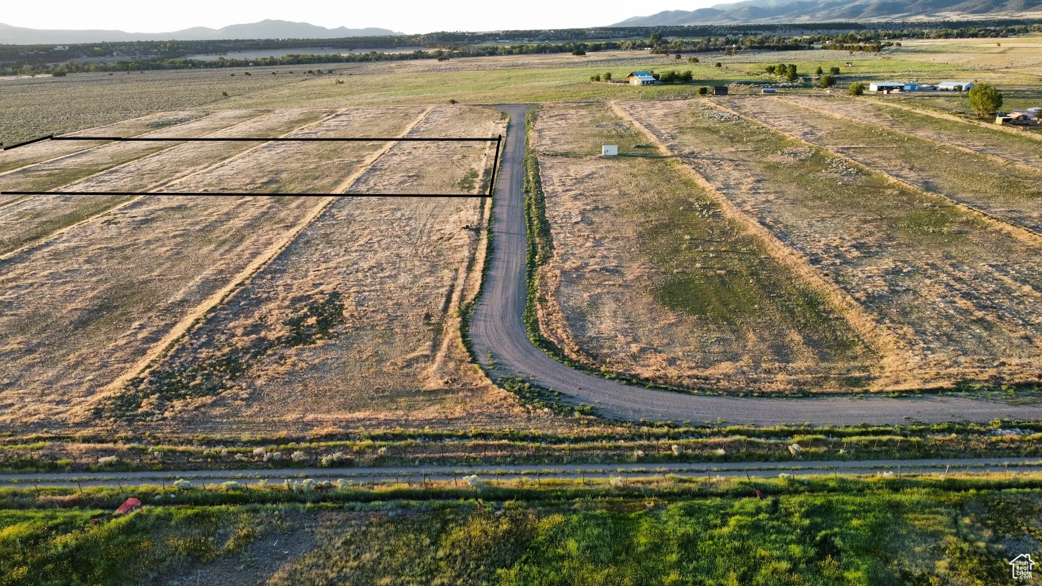 Aerial view of sparsely populated area featuring mountains and abundant farmland