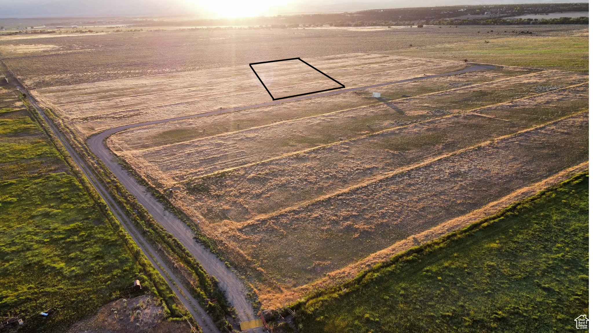 Aerial view of sparsely populated area featuring rows of crops and property boundaries highlighted