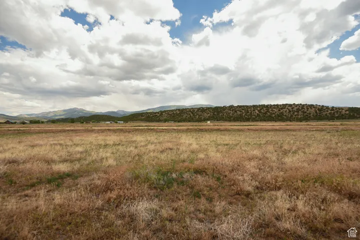 View of mountain backdrop featuring rural landscape