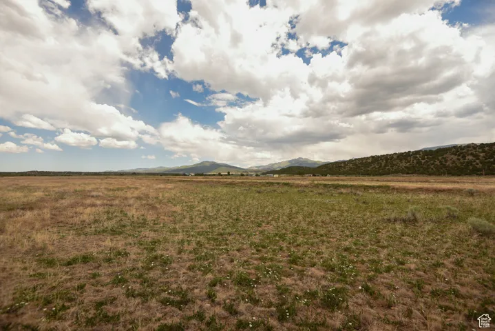 View of yard featuring a view of countryside and a mountain view