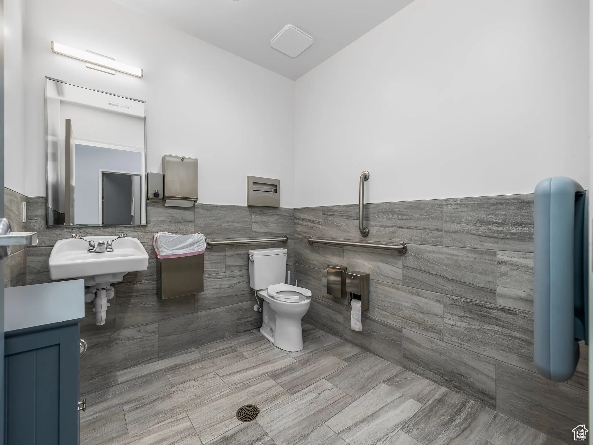 Bathroom with tile walls and wainscoting
