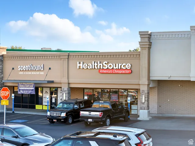 View of commercial property with uncovered parking