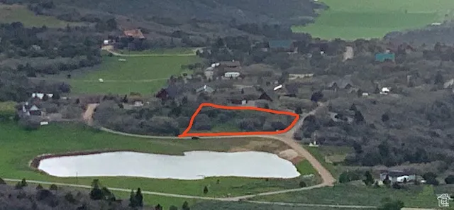 Aerial view of property and surrounding area with property parcel outlined