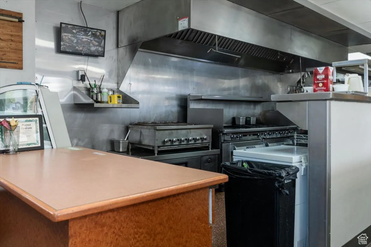 Kitchen with custom exhaust hood and open shelves