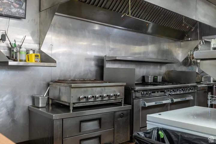 Kitchen with ventilation hood and stainless steel countertops