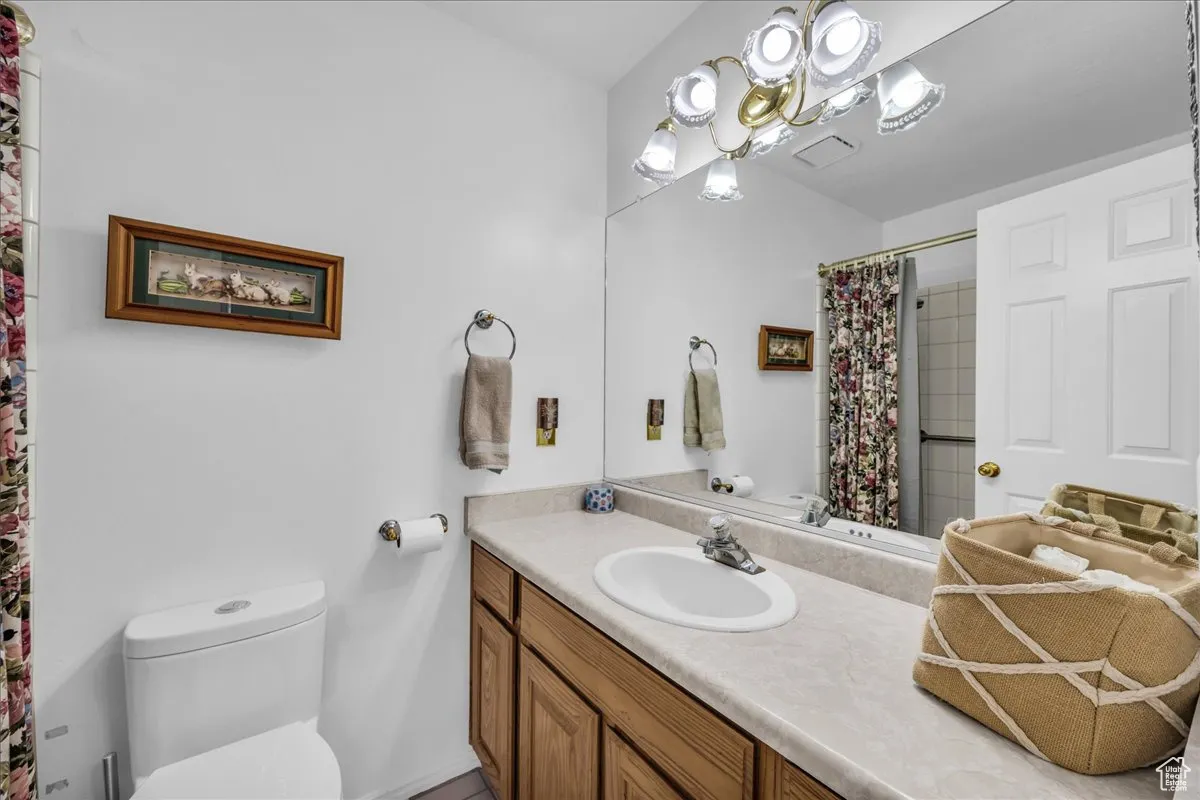 Bathroom with vanity and curtained shower