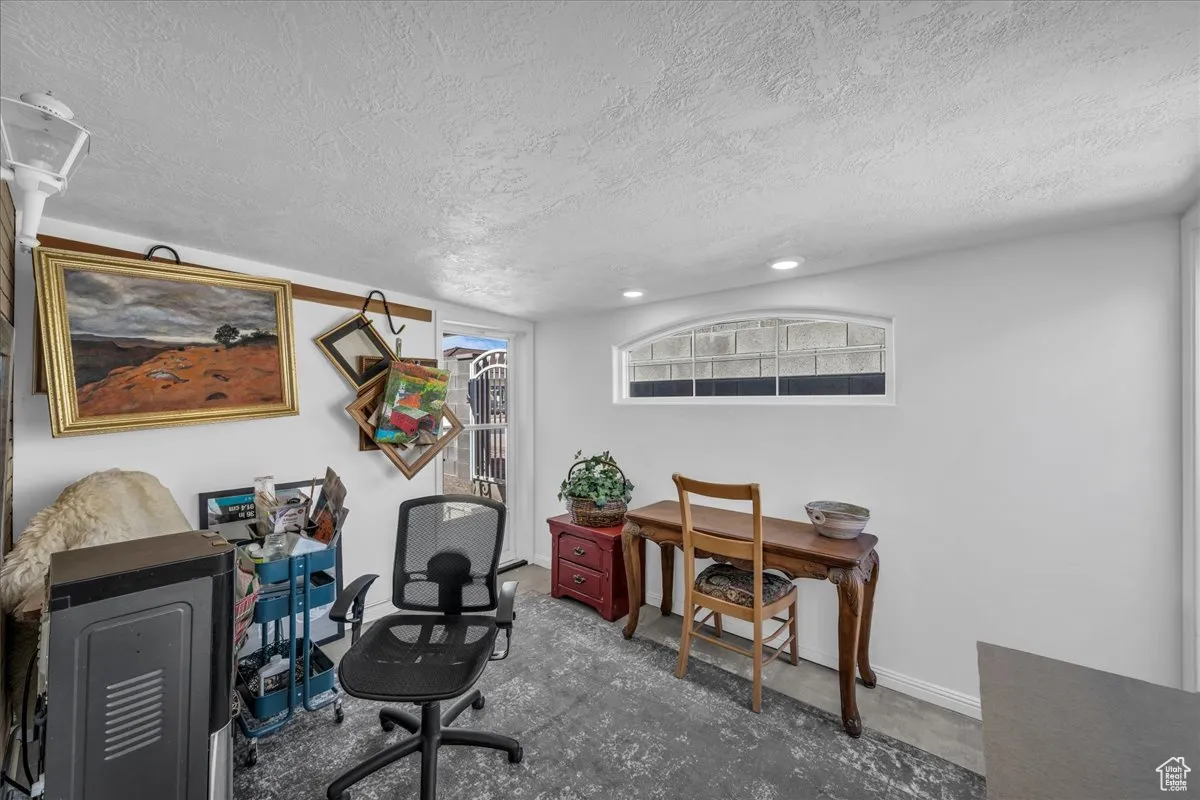 Office area featuring a textured ceiling and baseboards