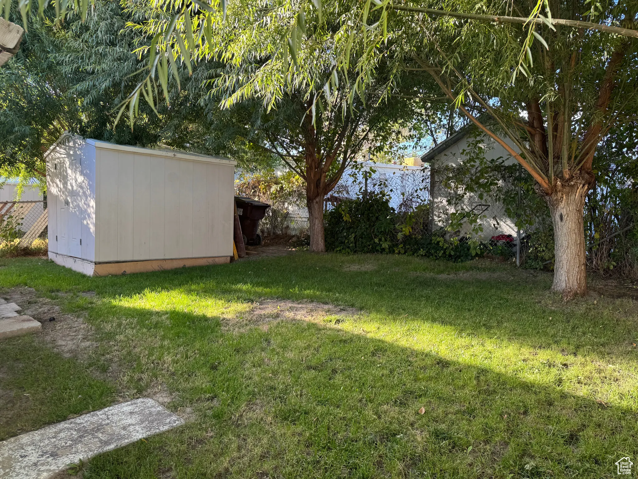 View of yard with a storage unit
