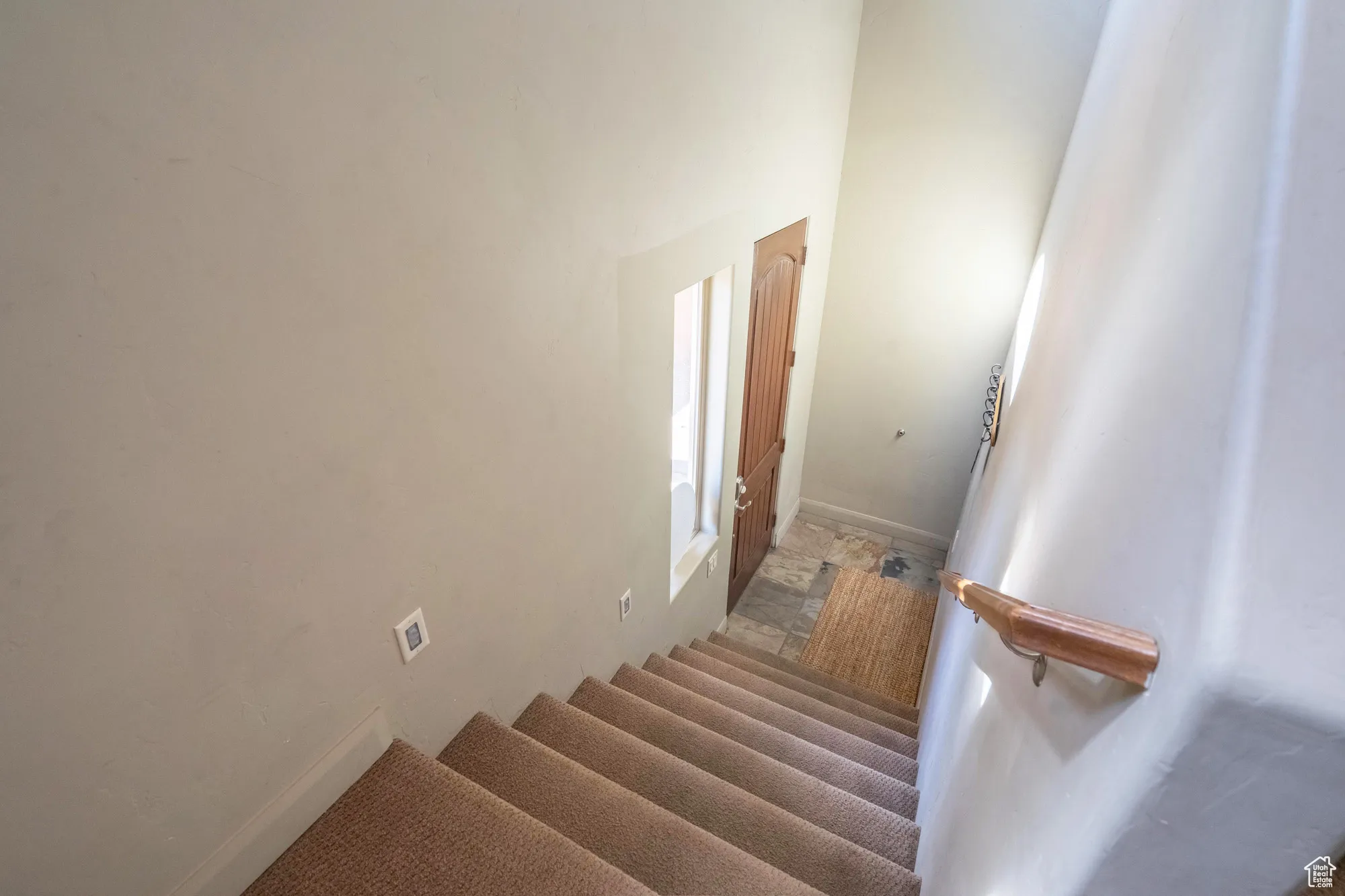 Staircase with carpet floors and a high ceiling