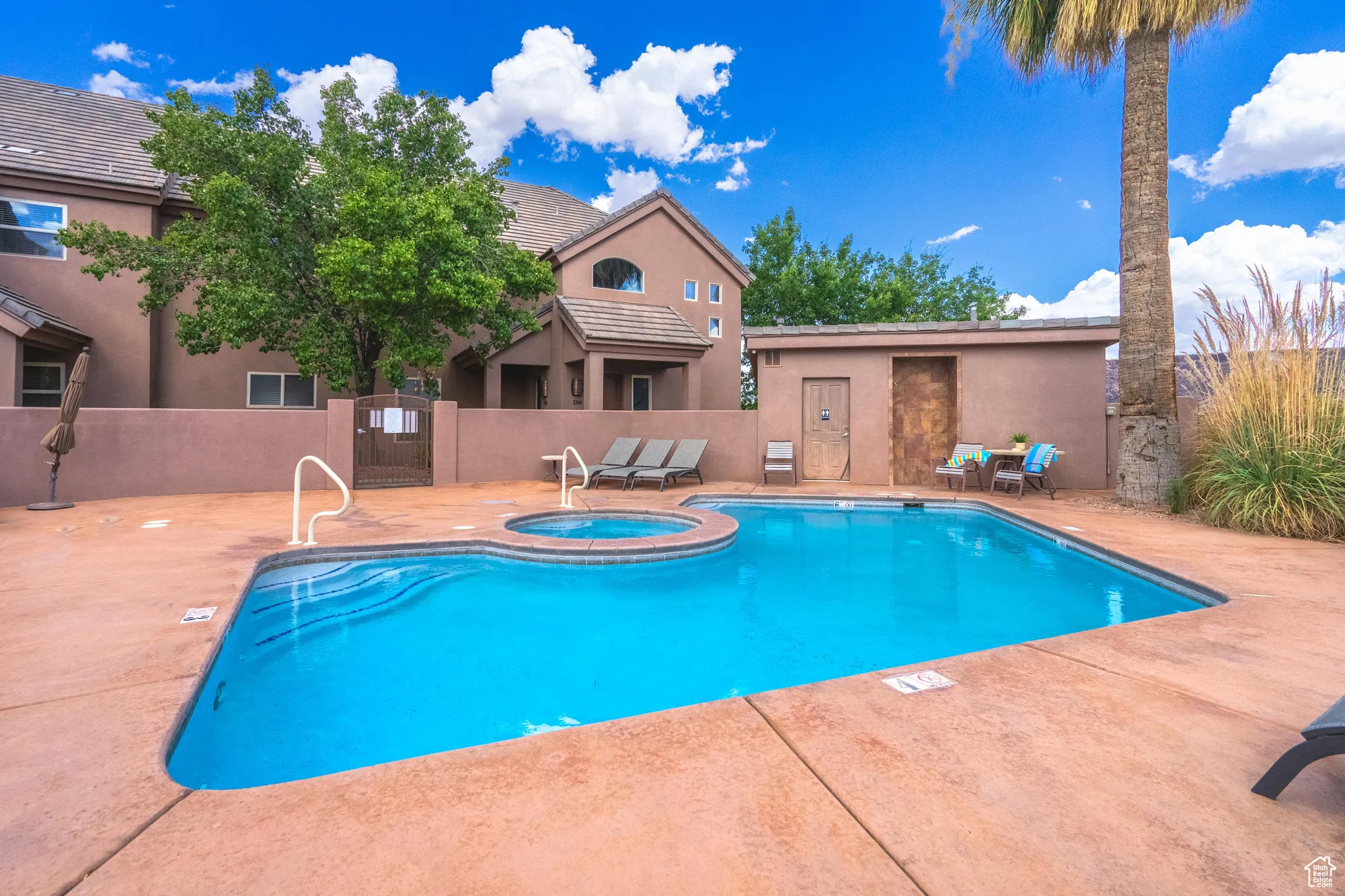 View of swimming pool with a patio and a pool with connected hot tub