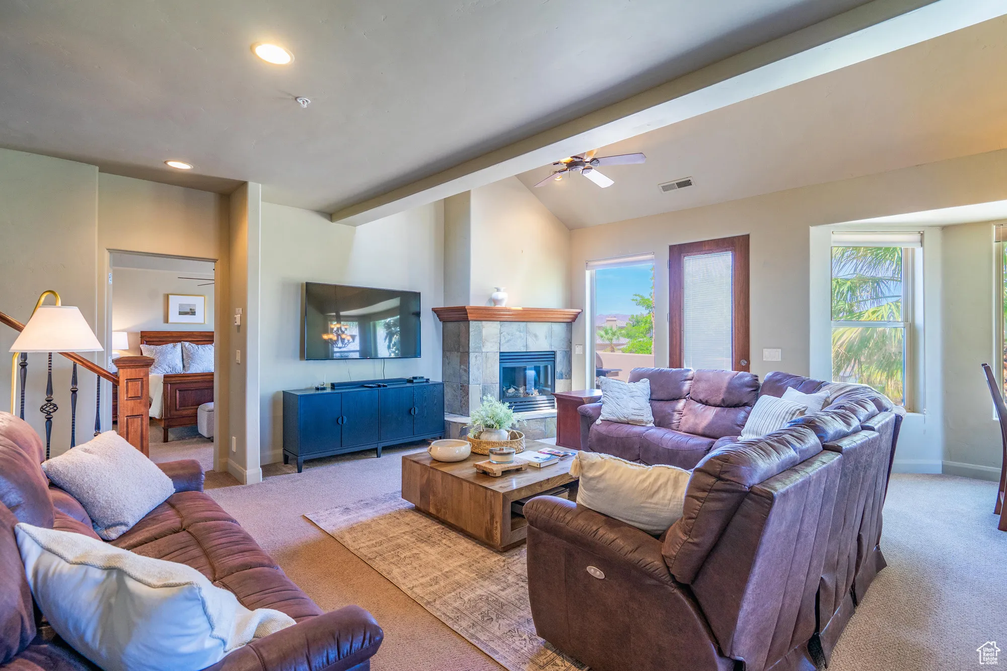 Living room featuring carpet floors, a ceiling fan, a fireplace, and recessed lighting