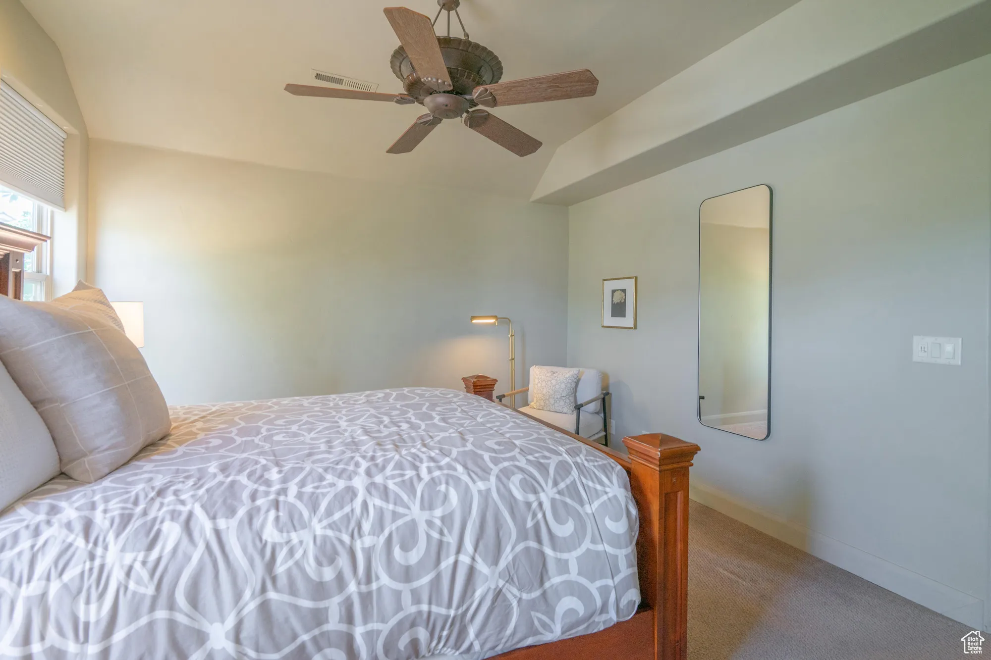 Bedroom featuring carpet floors, ceiling fan, and vaulted ceiling