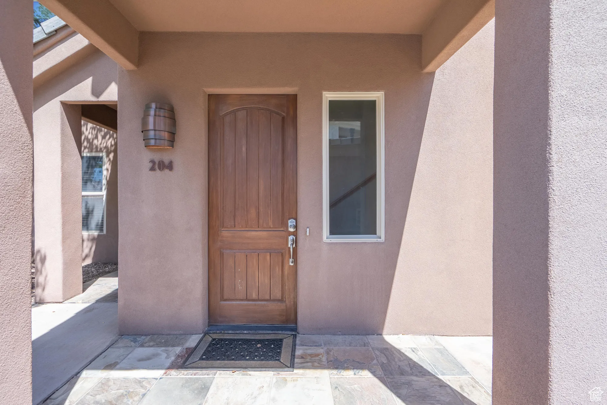 Property entrance featuring stucco siding