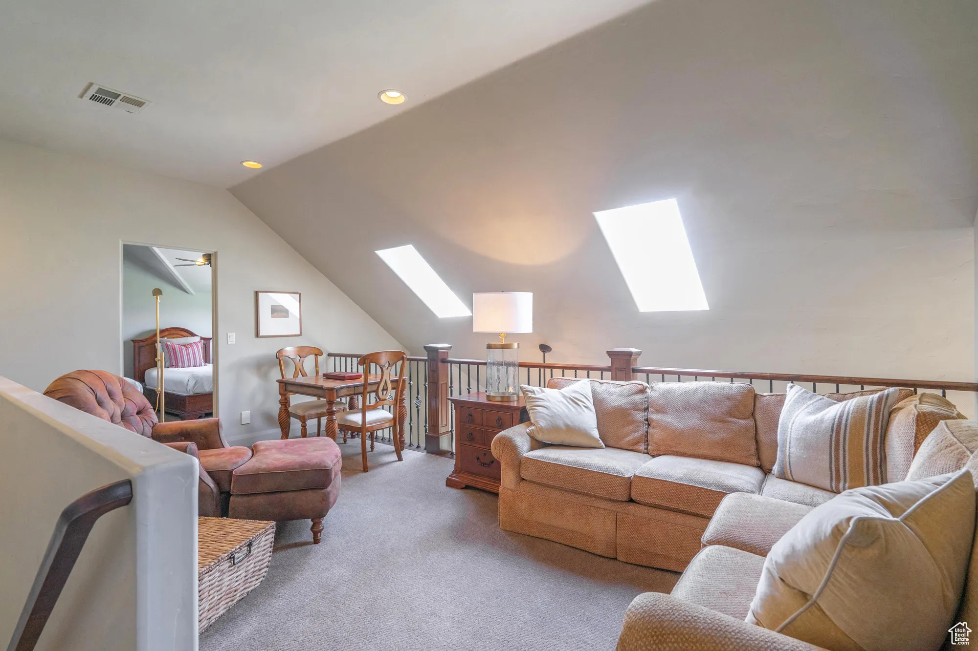 Living room featuring lofted ceiling, carpet flooring, a skylight, and recessed lighting