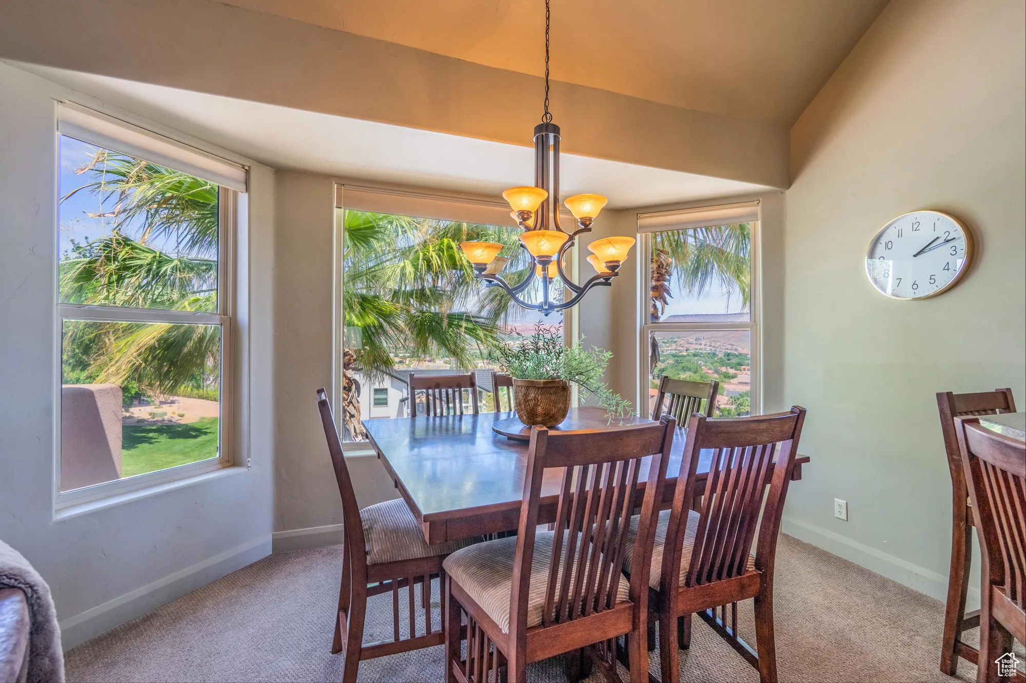 Dining room featuring light carpet, a chandelier, and vaulted ceiling