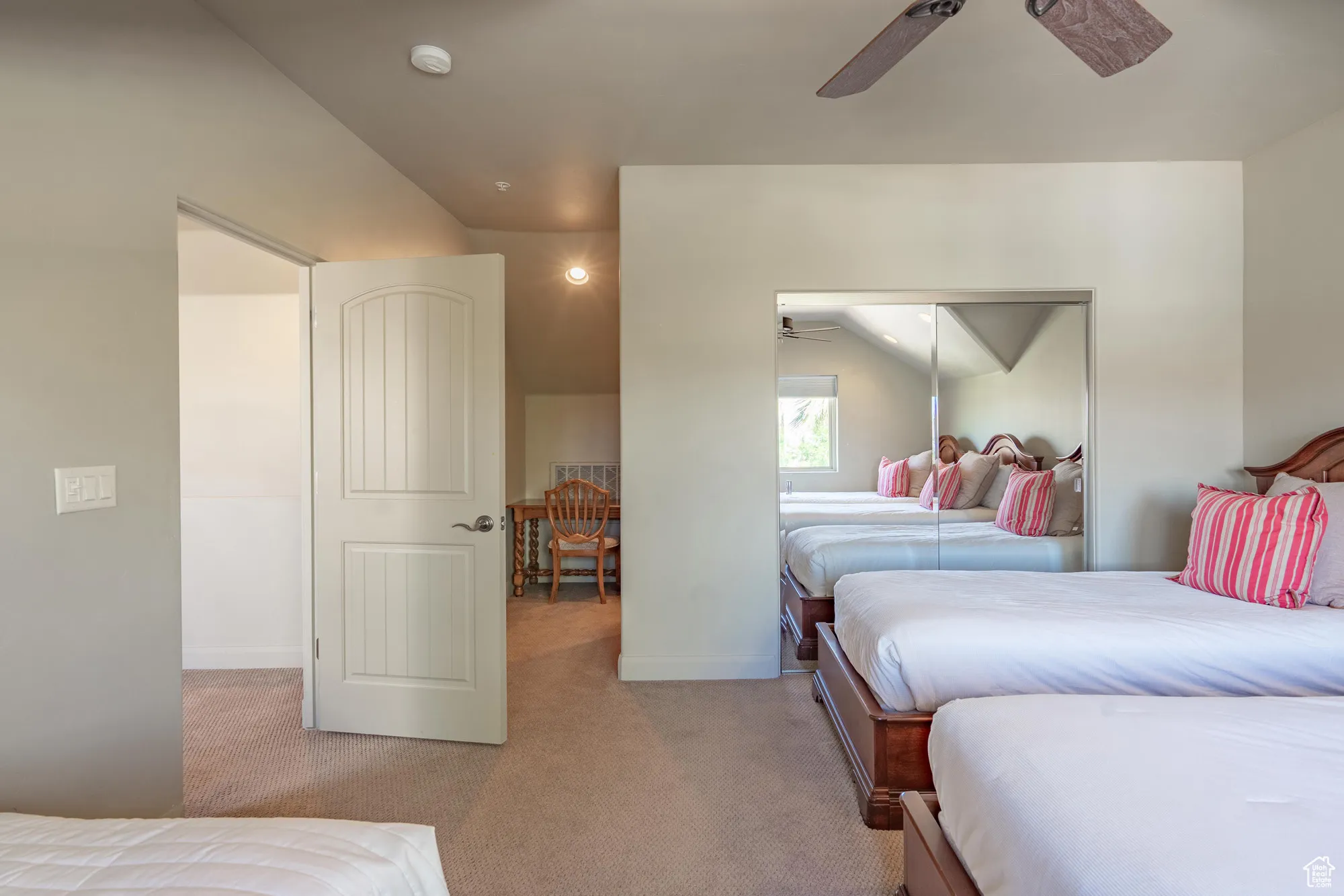 Bedroom featuring light carpet, a closet, and a ceiling fan