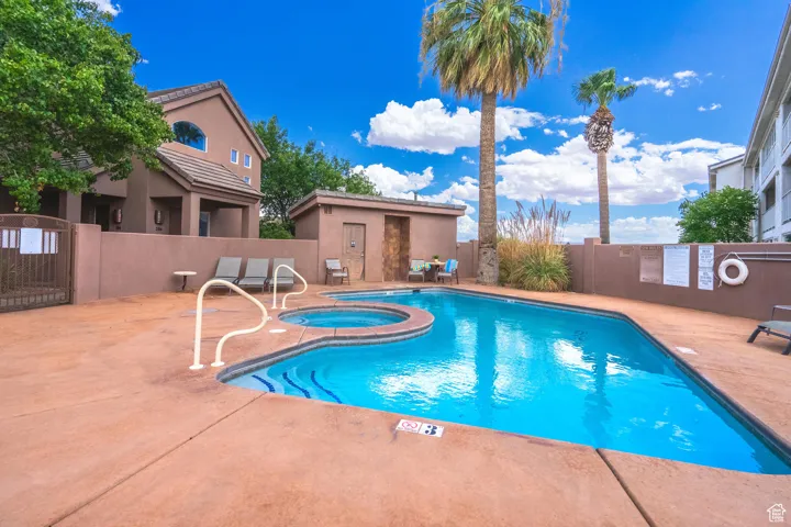 Community pool featuring a patio and a community hot tub