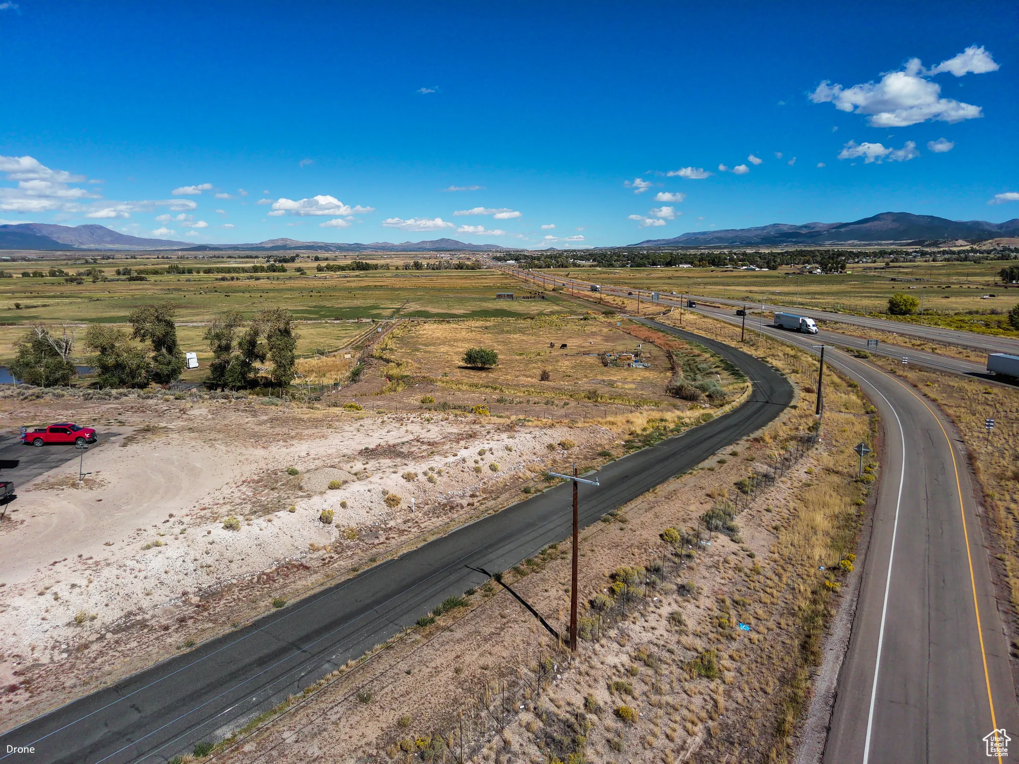 View of asphalt road with a mountain view and a view of rural / pastoral area