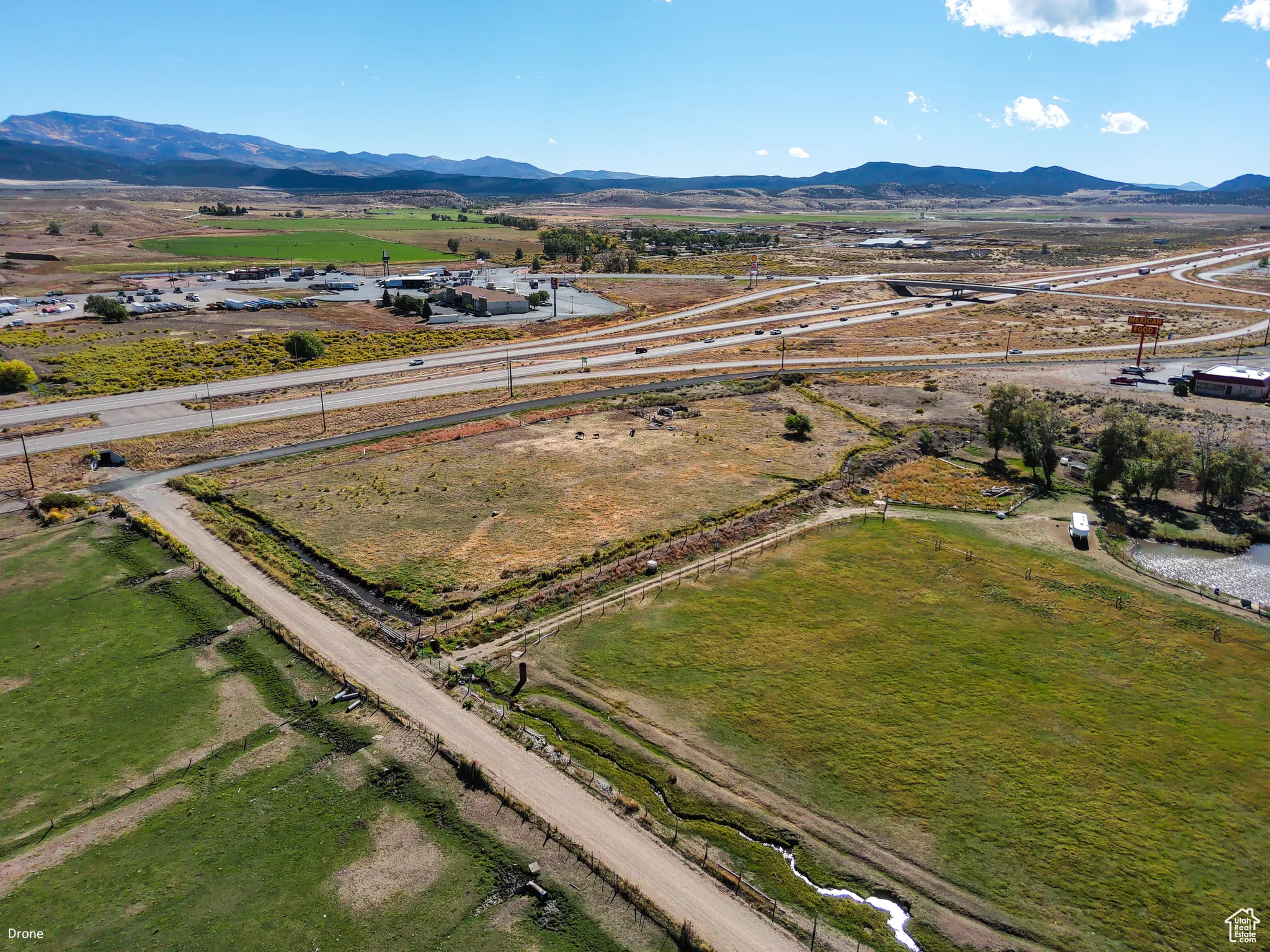 Aerial view of property's location with a mountain backdrop