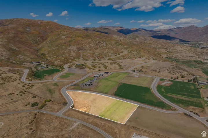 Aerial view of property's location with a mountain backdrop