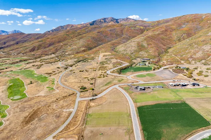 Aerial view of property and surrounding area featuring mountains and rural landscape