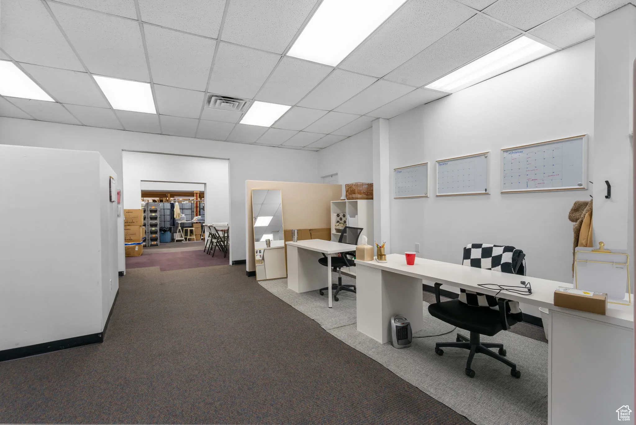 Carpeted home office with a drop ceiling