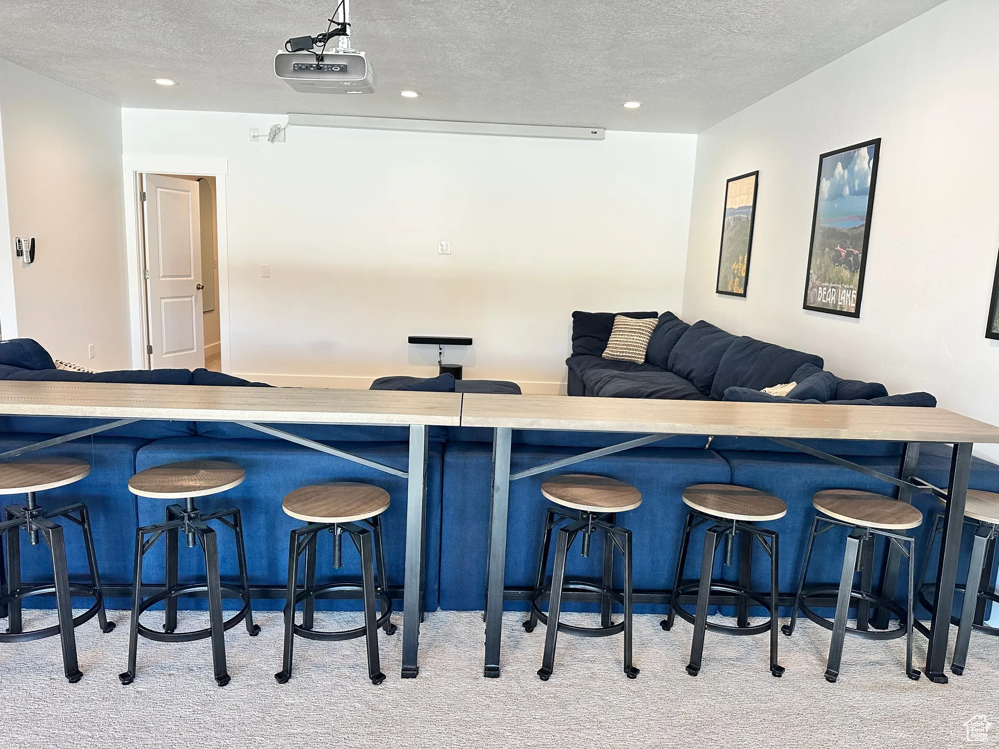 Bar area with a textured ceiling, light countertops, and recessed lighting