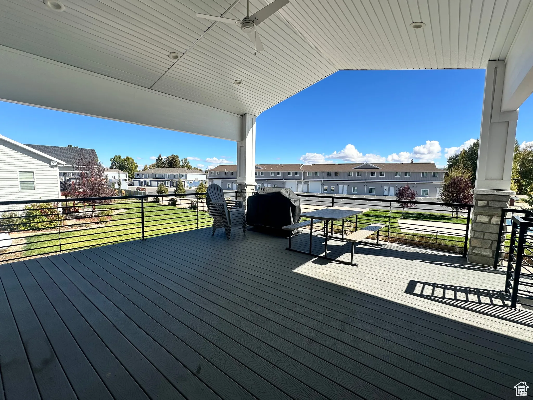 Deck featuring a residential view and ceiling fan