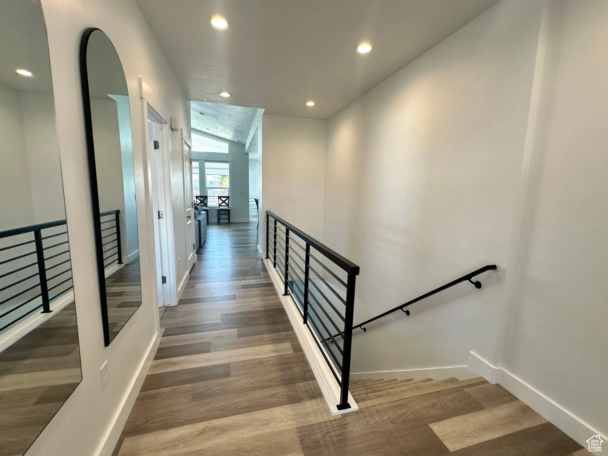 Stairs featuring recessed lighting and wood finished floors