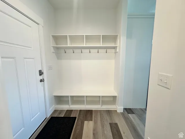 Mudroom featuring dark wood-style floors