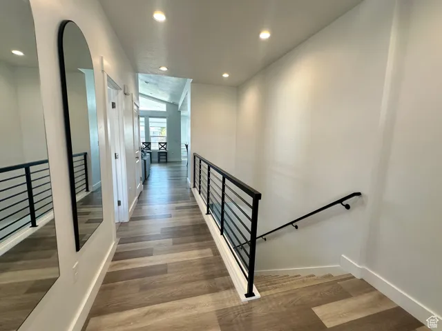 Stairs featuring recessed lighting and wood finished floors