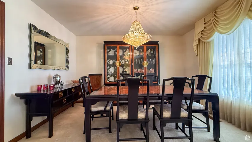 Dining room featuring a chandelier and baseboards