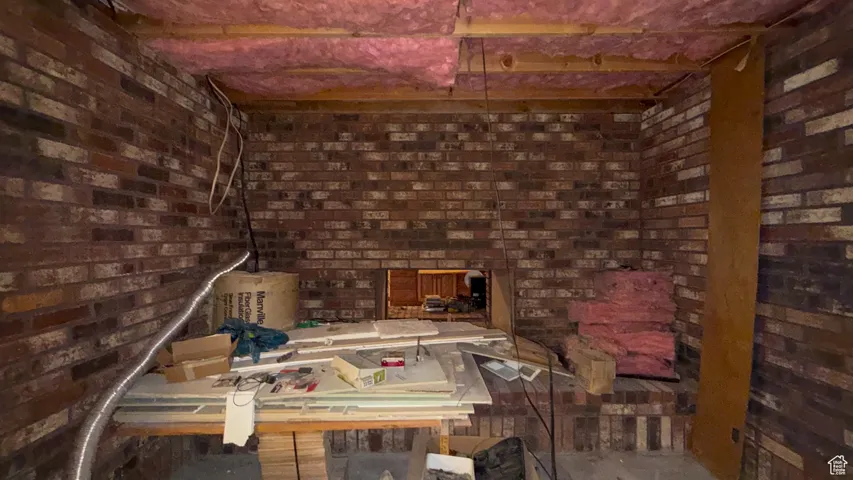 Misc room featuring brick wall