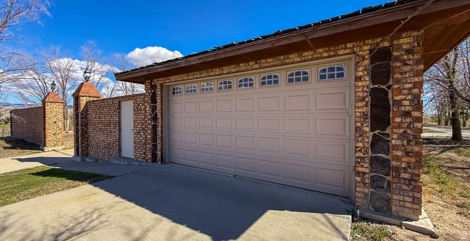 Garage featuring concrete driveway