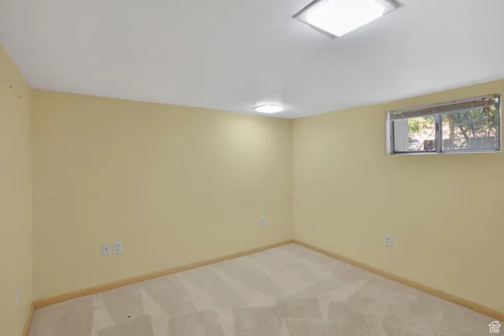 Unfurnished room with carpet and baseboards