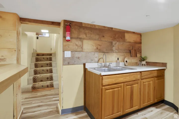 Kitchen featuring light countertops, light wood-style floors, and brown cabinetry
