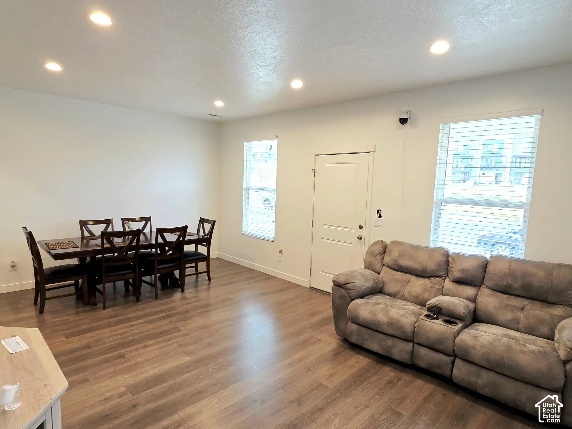 Living area featuring recessed lighting, wood finished floors, and a textured ceiling