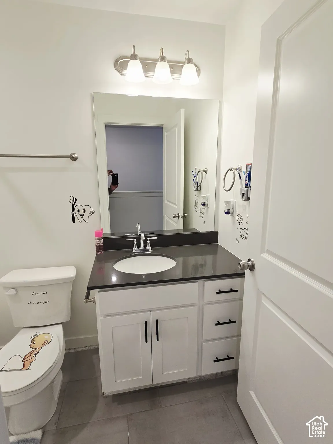 Half bath featuring vanity and light tile patterned floors