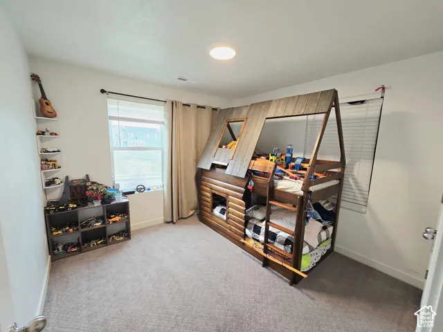 Bedroom with carpet flooring and baseboards
