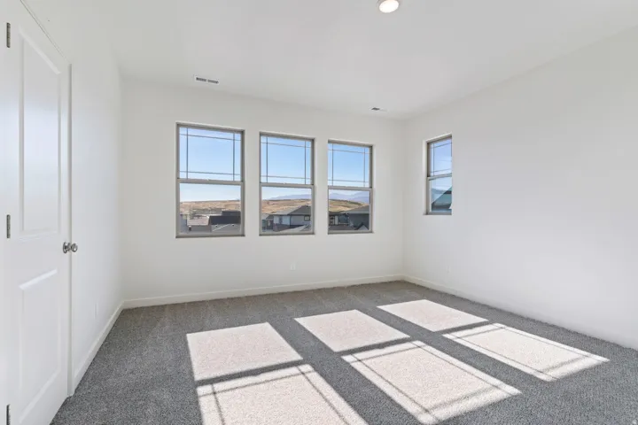 Carpeted empty room featuring baseboards and recessed lighting