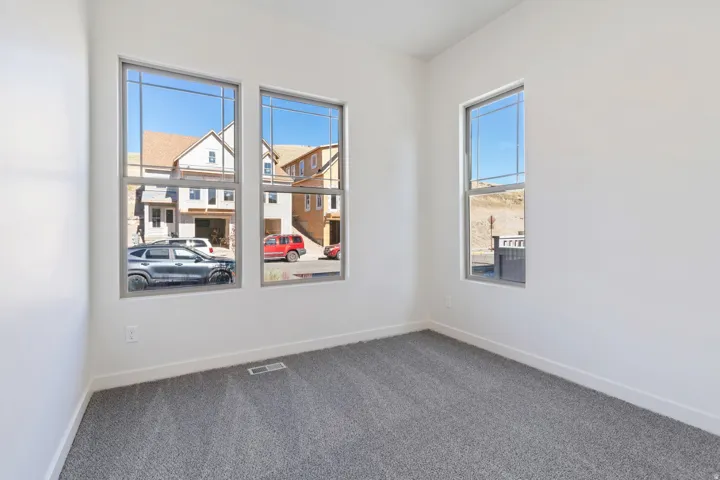 Carpeted empty room with baseboards